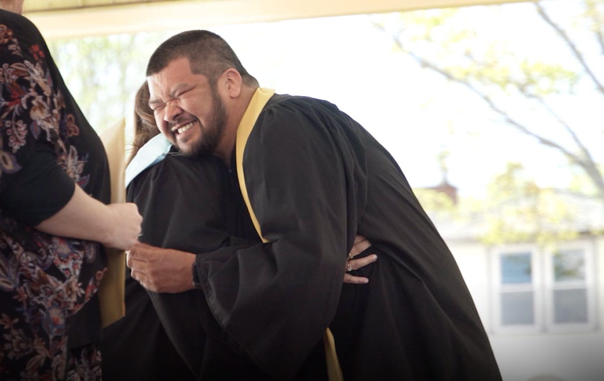Man graduating from a Jane Norman College Youth Worker Program
